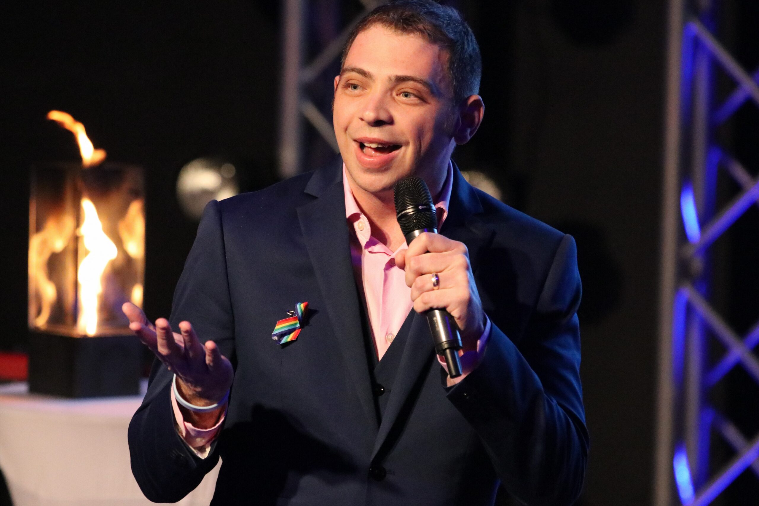 Thommy Sandvick speaking on stage to a full room