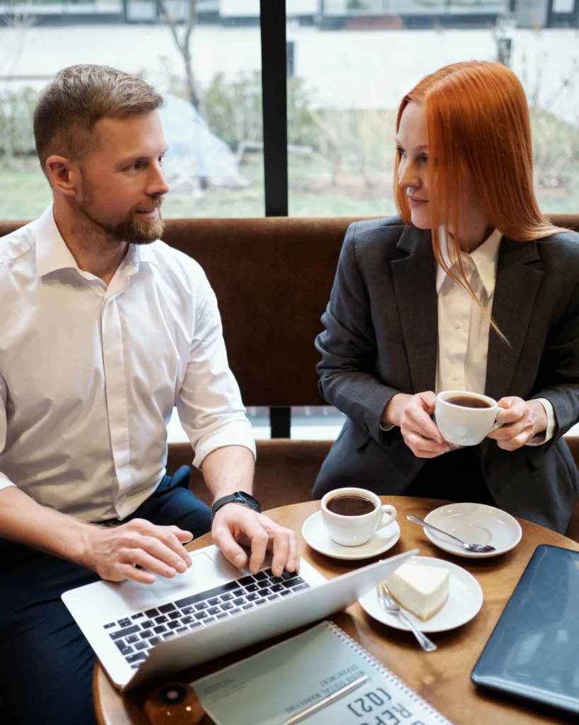 Coach and client talking over coffee