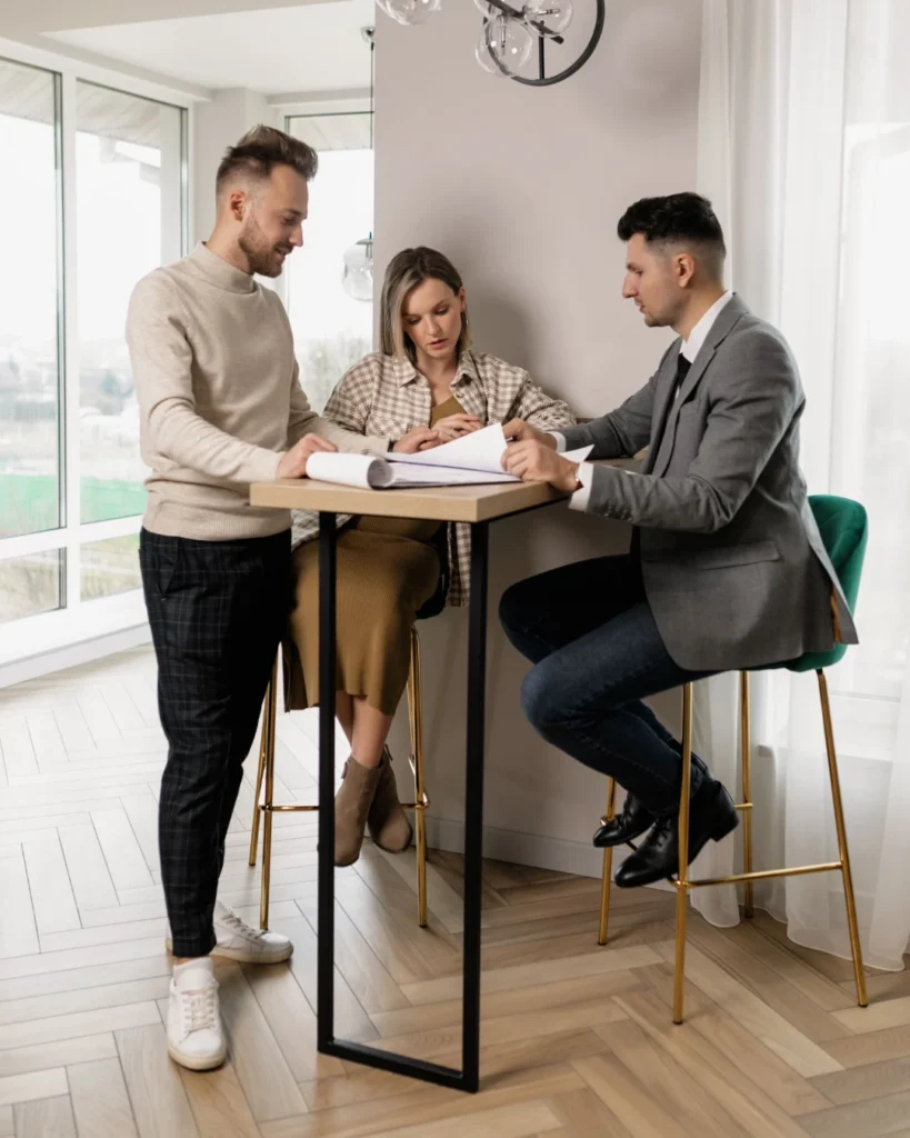 Loan officer going over mortgage paperwork with a couple