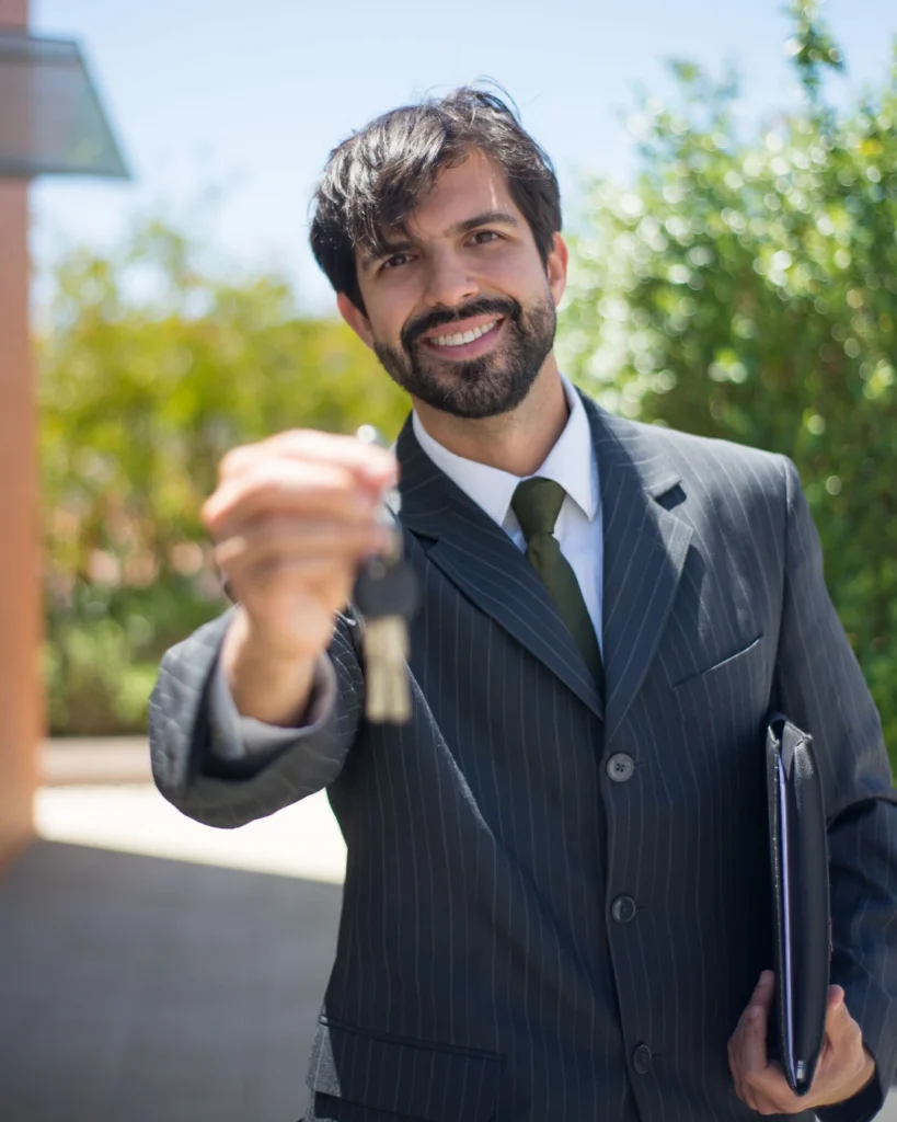 Real estate agent handing house keys to a buyer