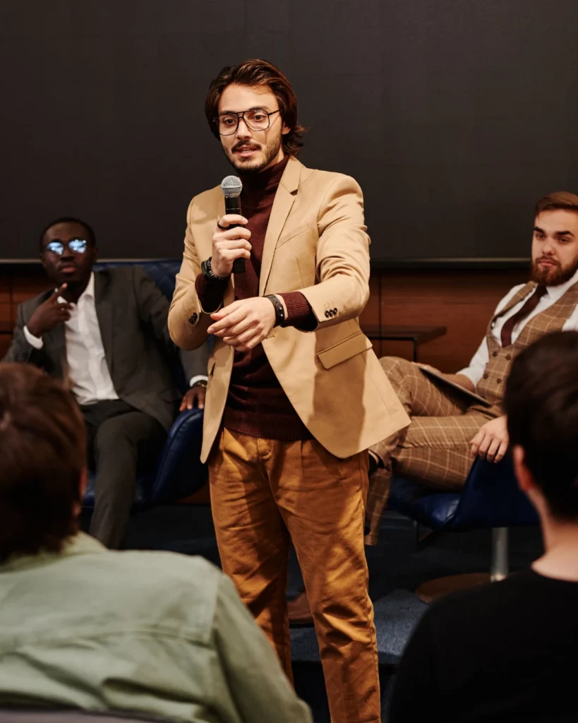 Speaker talking with audience members after a talk
